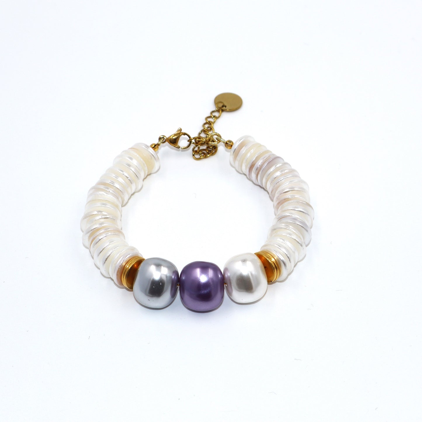 Pearl bracelet with gold accents on a white background