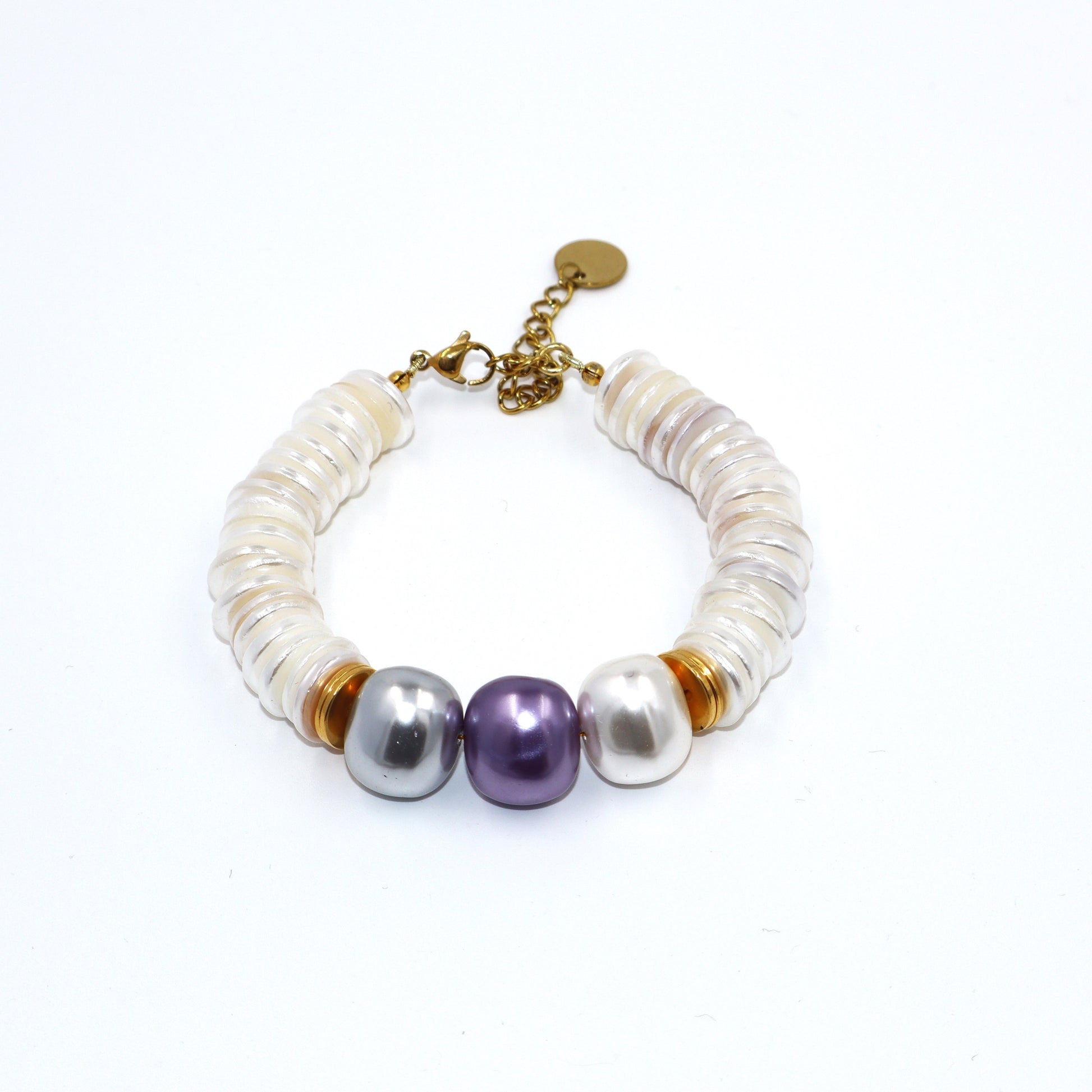 Pearl bracelet with gold accents on a white background