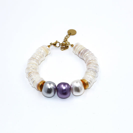 Pearl bracelet with gold accents on a white background