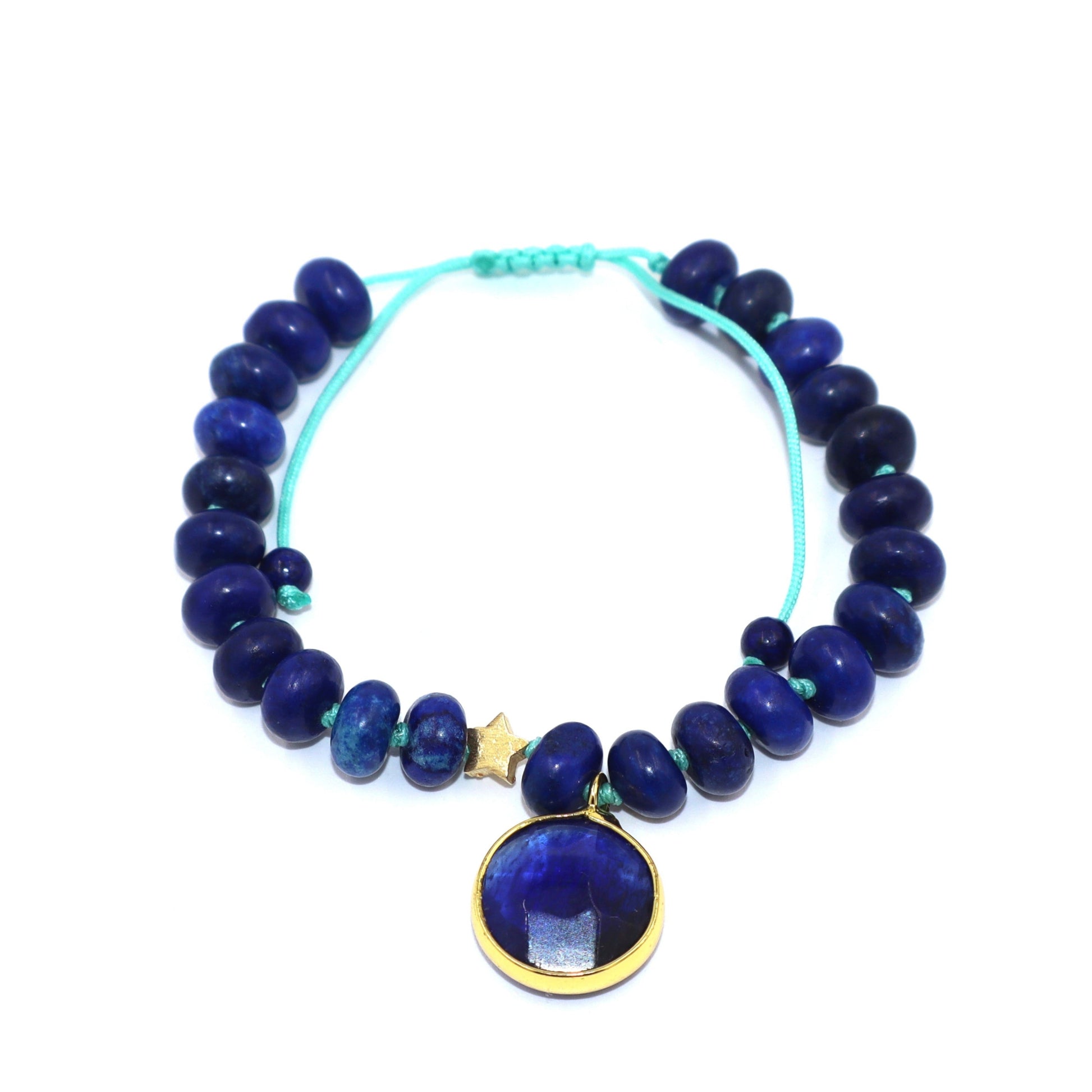 Blue beaded bracelet with a gold accent on a white background